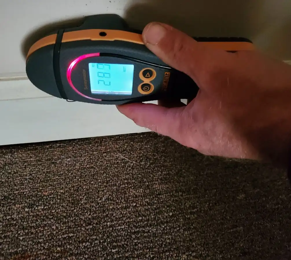 Moisture detection at baseboard during Storm Damage Restoration in Fort Madison